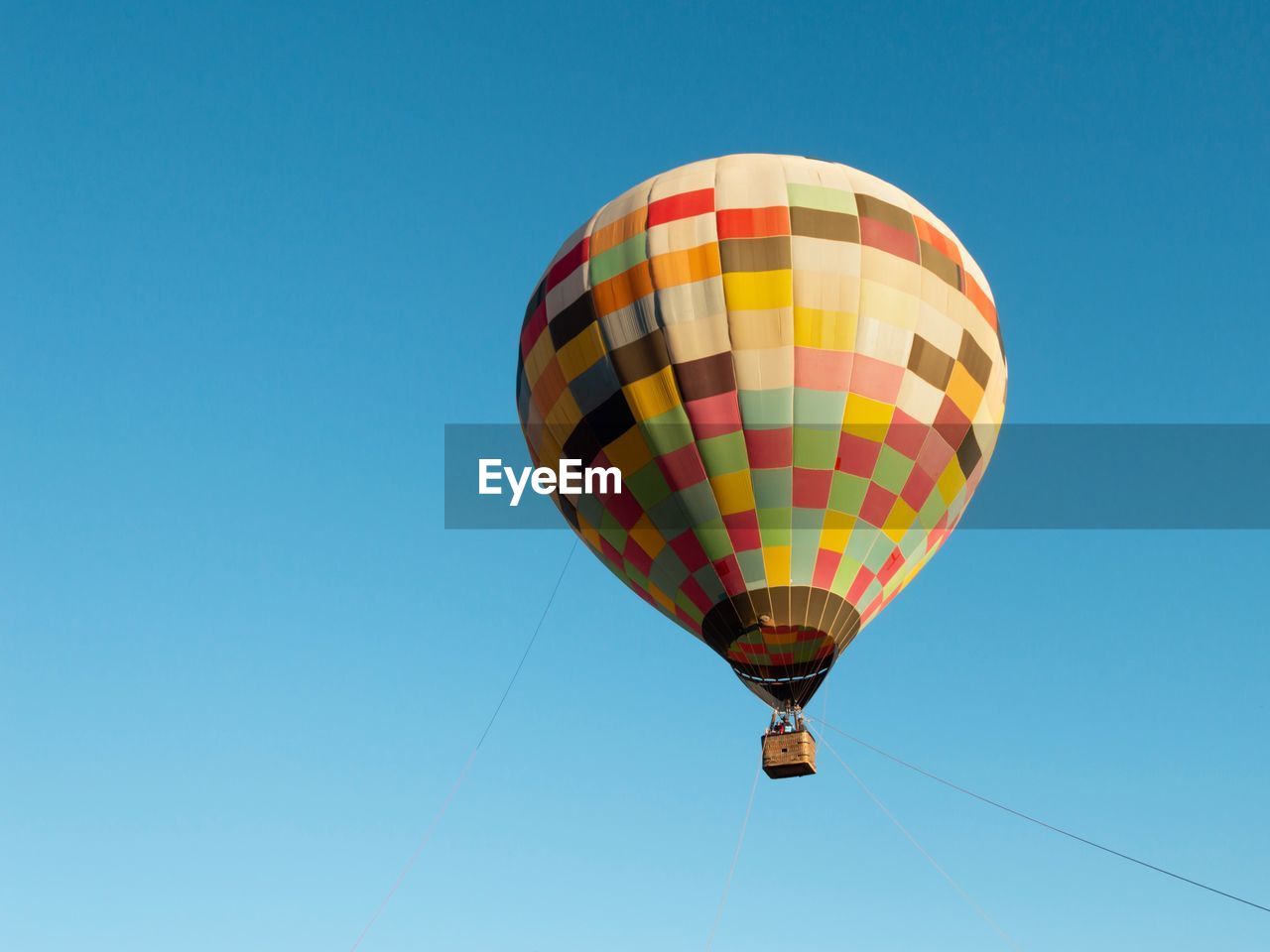 Low angle view of hot air balloon against clear blue sky