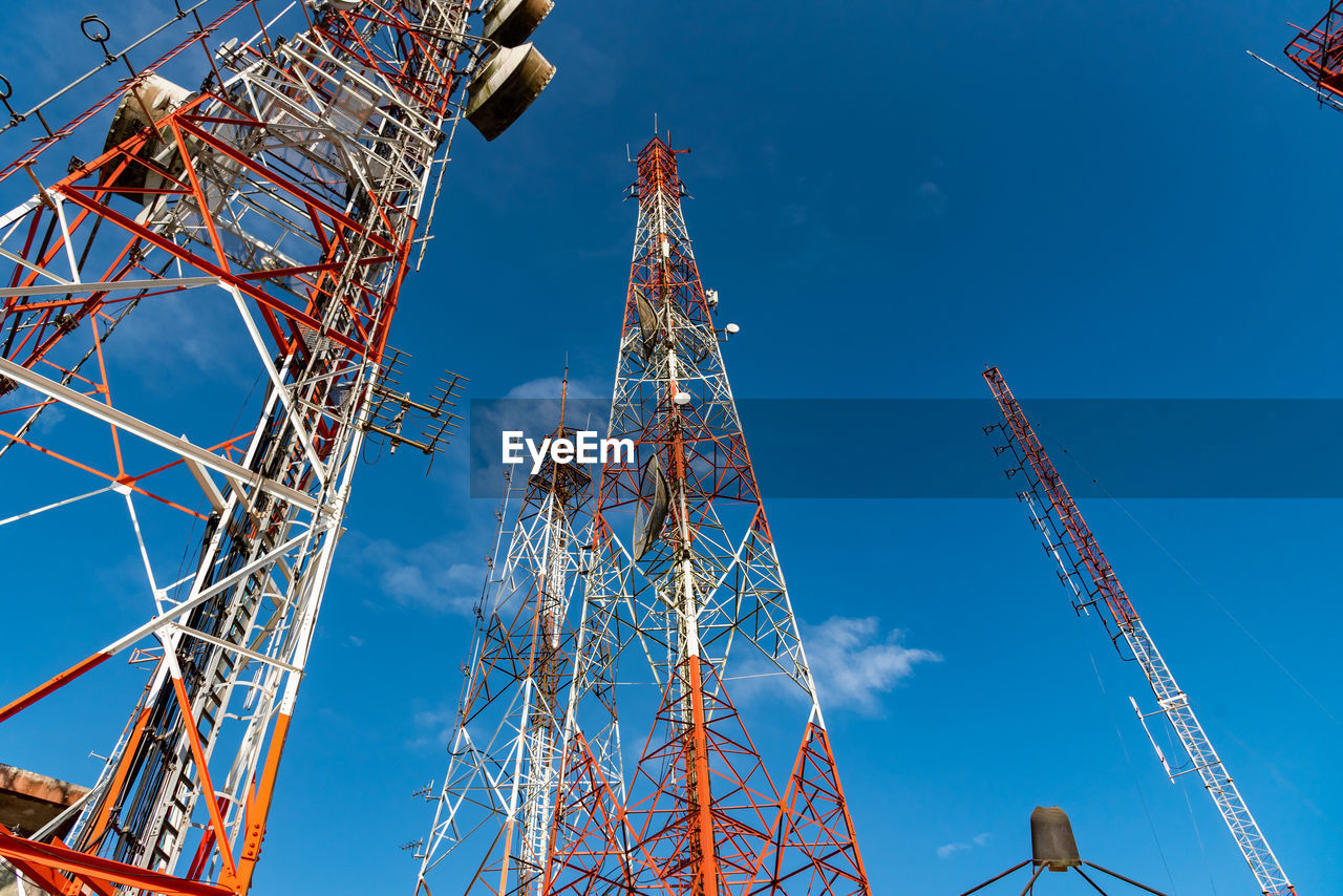 Group of telecommunication towers with blue sky background.