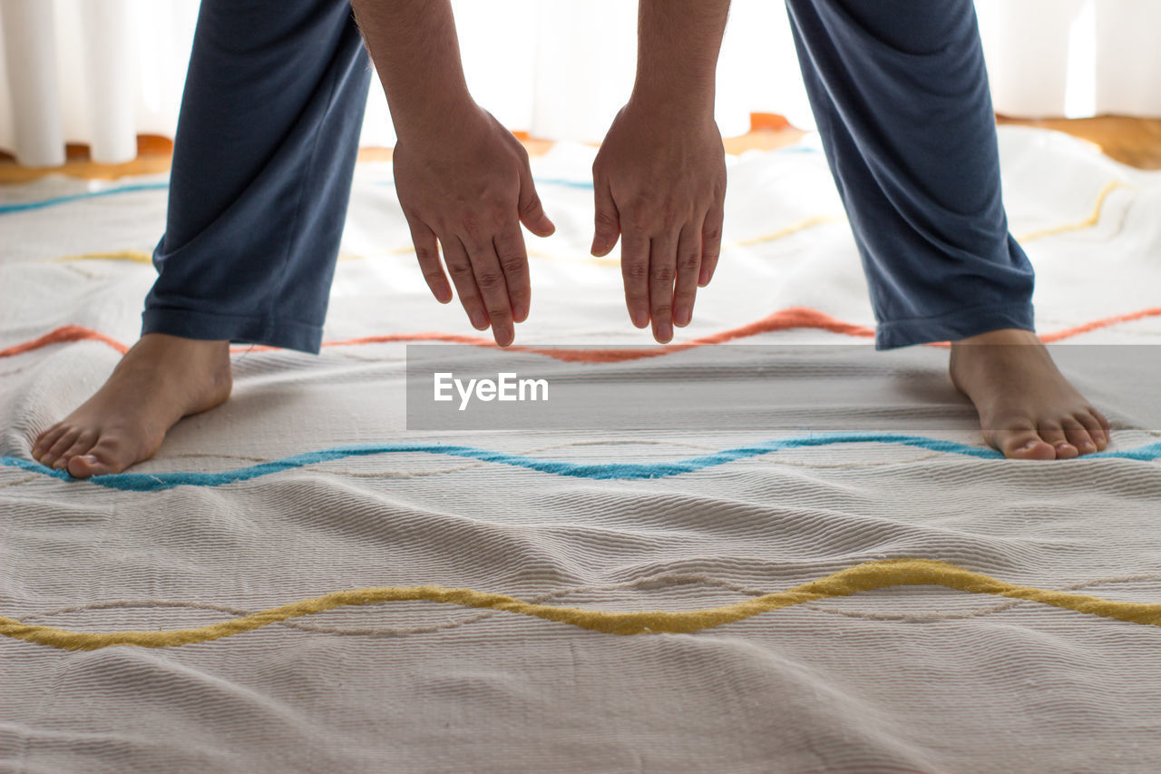 Low section of woman exercising at home