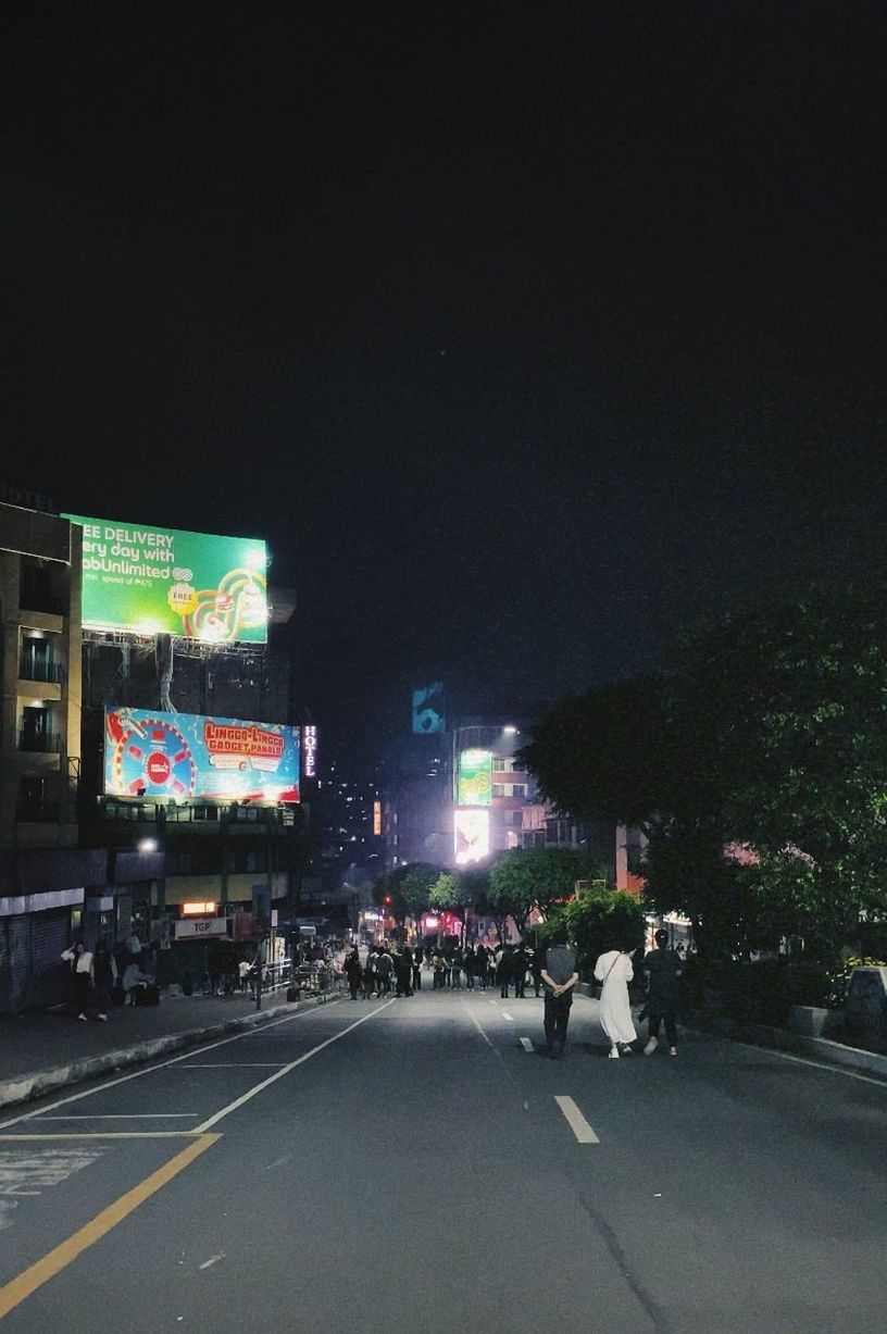 night, city, architecture, illuminated, transportation, street, lighting, road, group of people, building exterior, built structure, crowd, sign, light, mode of transportation, car, large group of people, sky, motor vehicle, city life, city street, outdoors, nature, billboard, highway, darkness