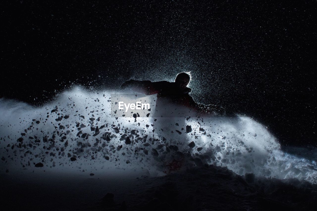 Man snowboarding at night