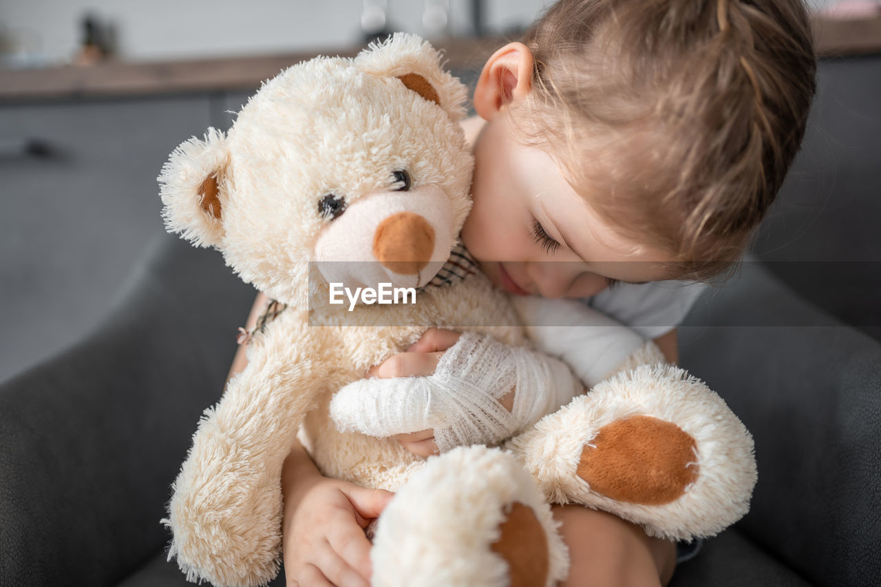 portrait of cute baby boy with teddy bear