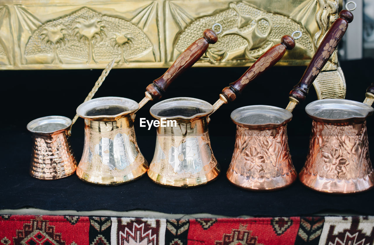 CLOSE-UP OF OLD OBJECTS ON TABLE AT MARKET