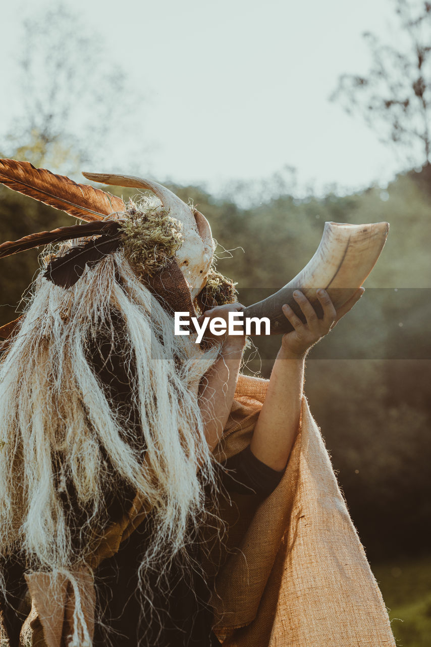 Shaman invoking the spirits in a ceremony in a forest