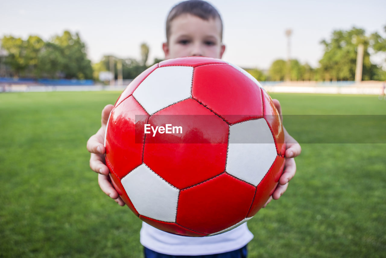 low section of man playing soccer on field