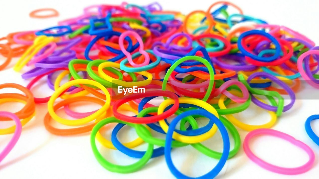 Close-up of colorful rubber bands over white background