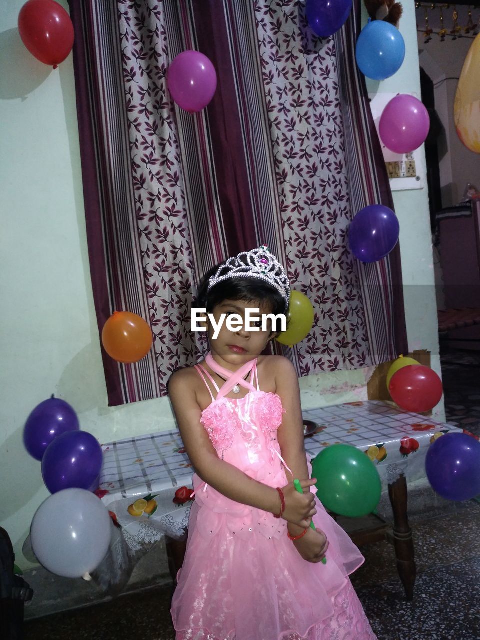 PORTRAIT OF BOY WITH BALLOONS AT NIGHTCLUB