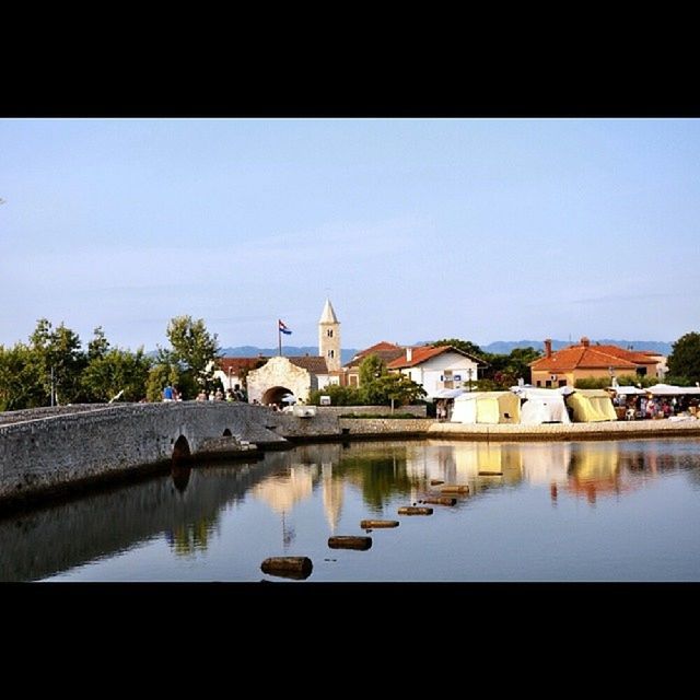 RIVER WITH BUILDINGS IN BACKGROUND