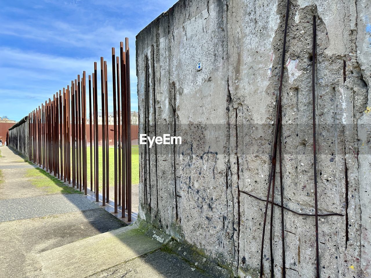 wall, architecture, built structure, sky, day, no people, nature, wall - building feature, wood, fence, outdoors, building exterior, in a row, sunlight, facade, footpath, cloud, urban area, building, security