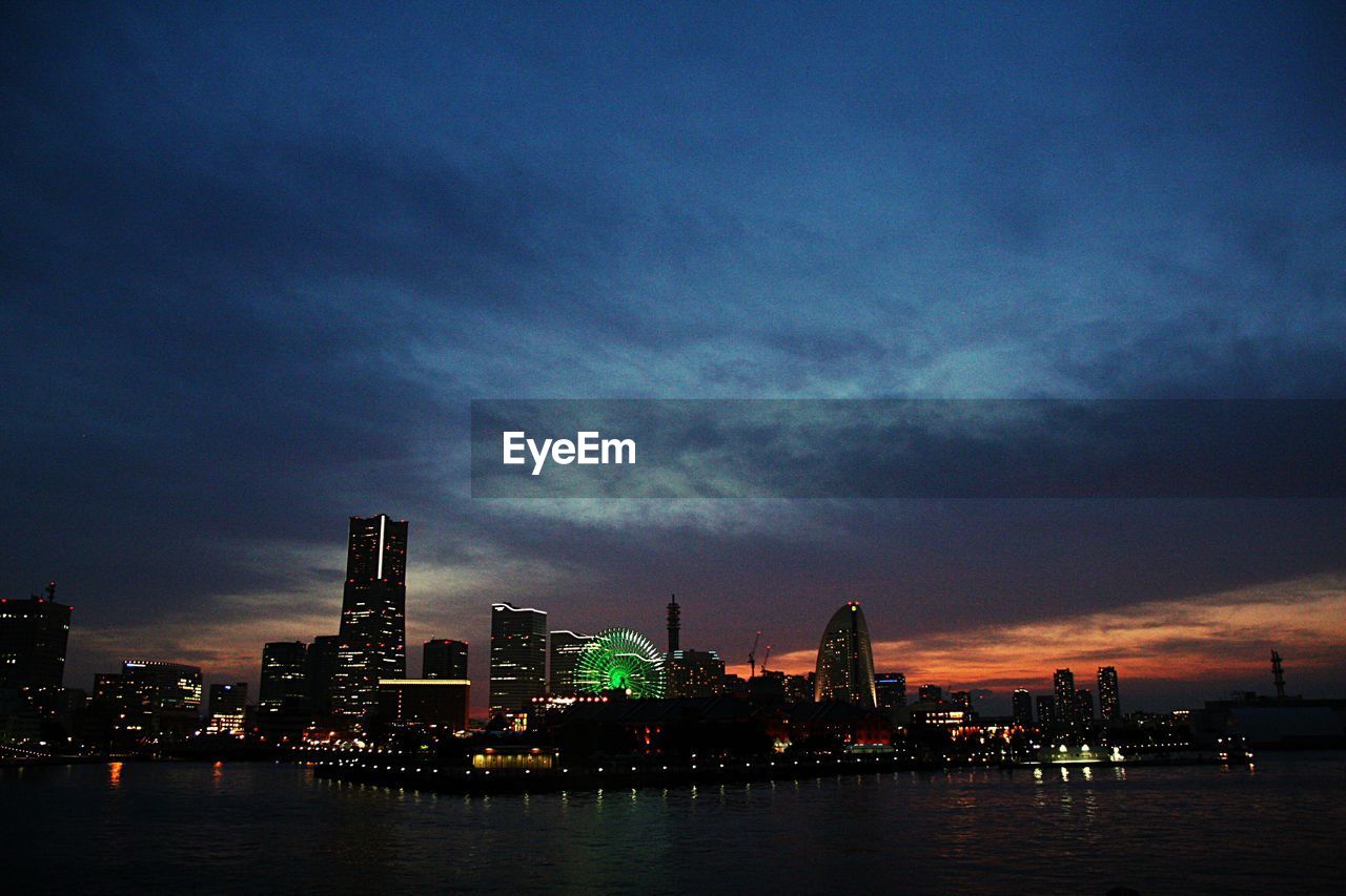 CITY AT WATERFRONT DURING SUNSET