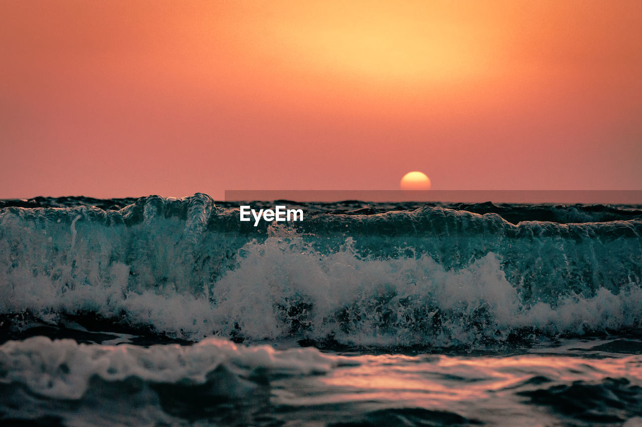 Scenic view of sea against clear sky during sunset