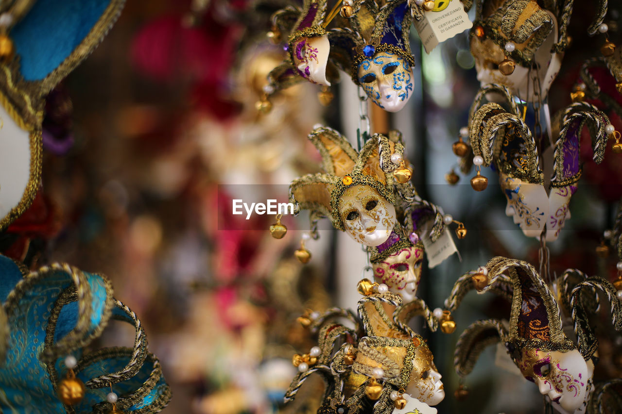 Close-up of small venetian mask hanging for sale
