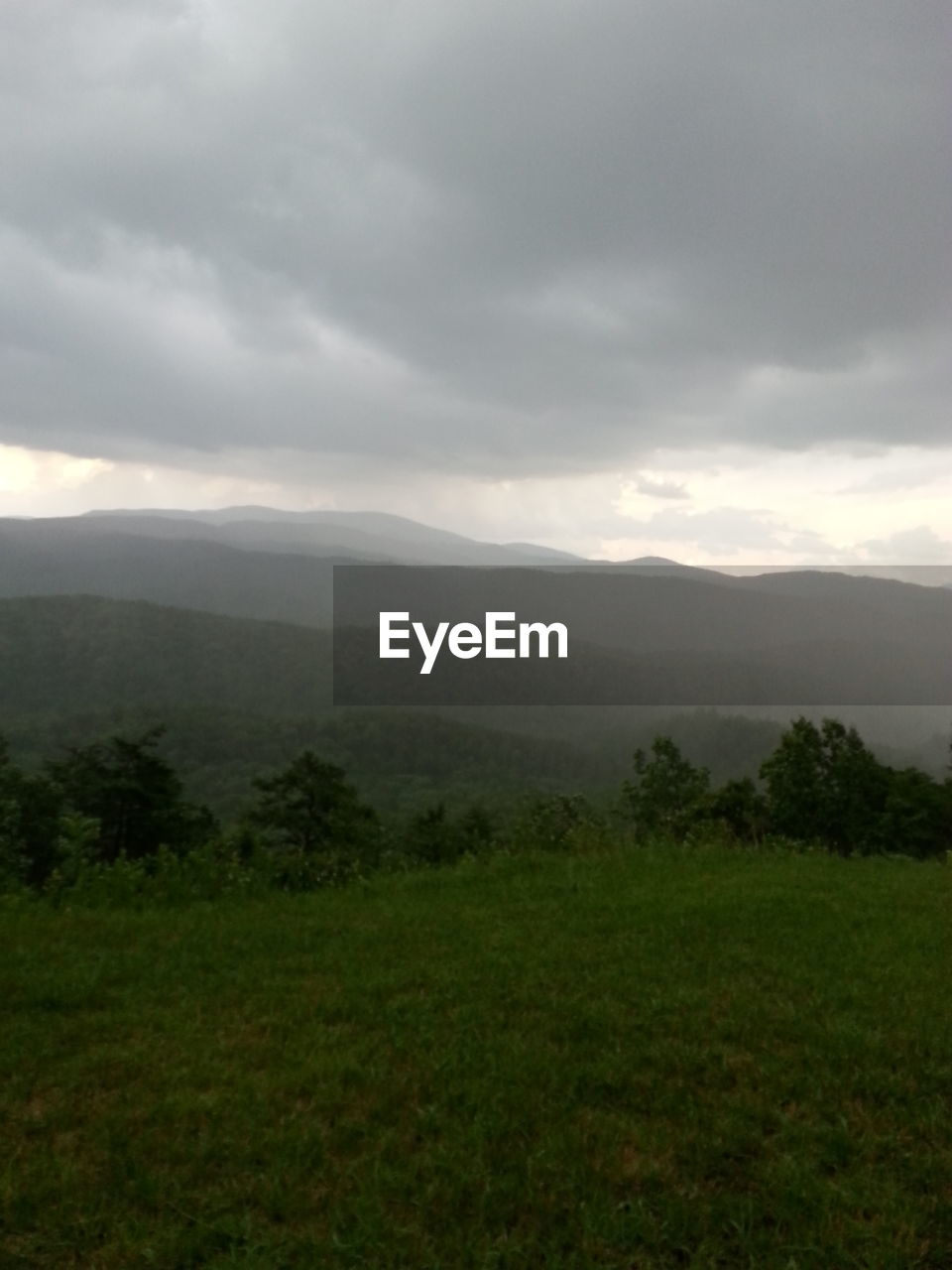 SCENIC VIEW OF MOUNTAINS AGAINST CLOUDY SKY