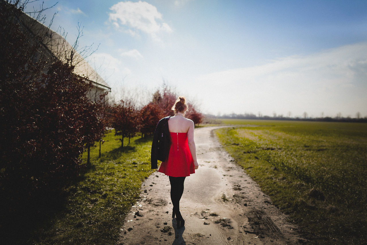 Rear view of young woman in red dress