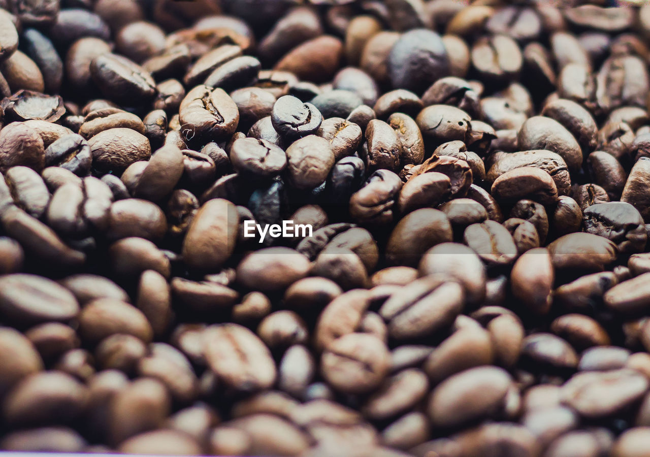 FULL FRAME SHOT OF COFFEE BEANS IN BACKGROUND