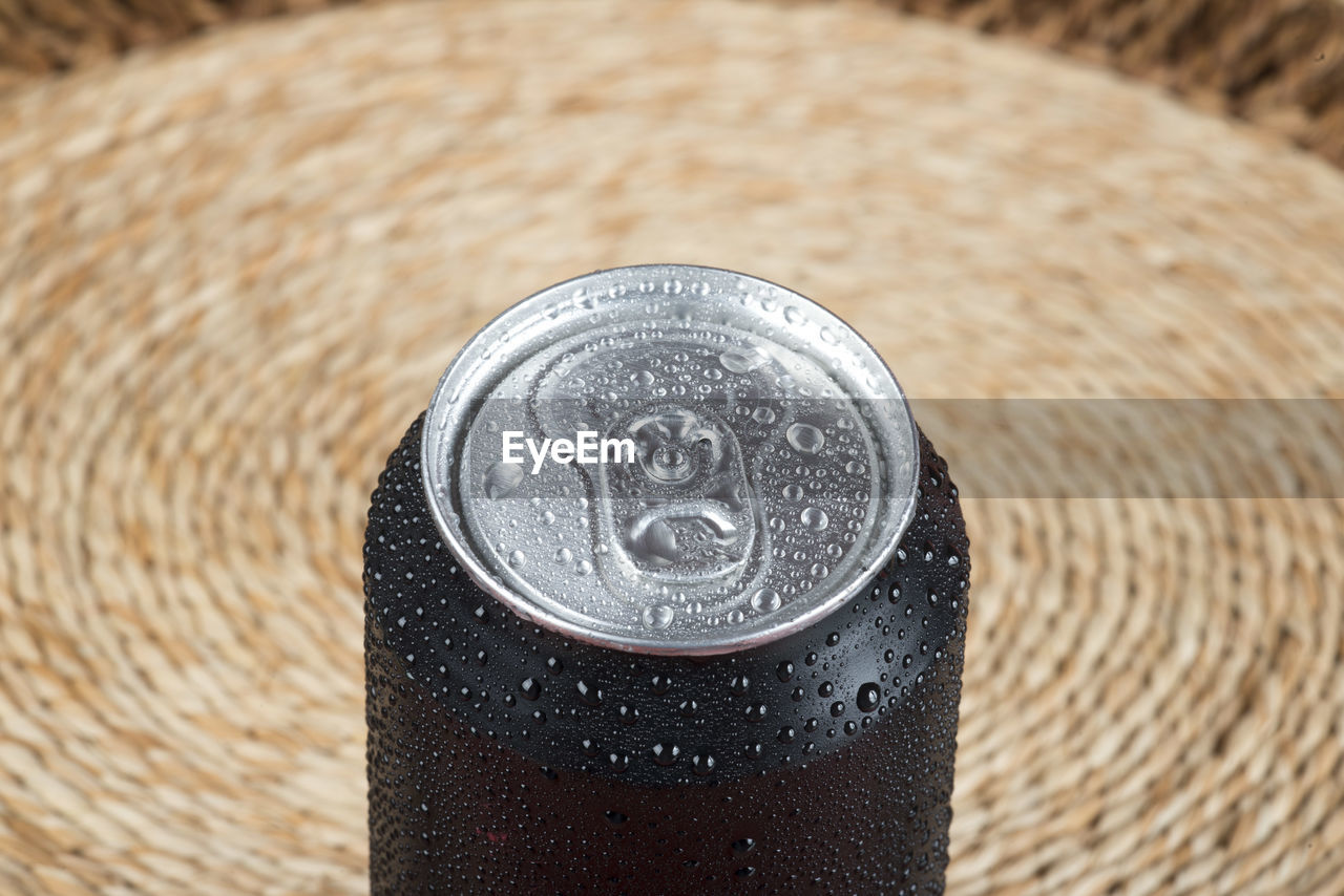 Black aluminum can, with drops of water.