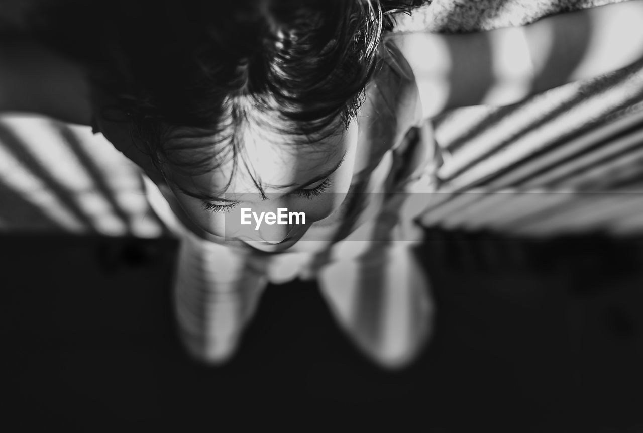 Upside down image of girl relaxing on carpet at home