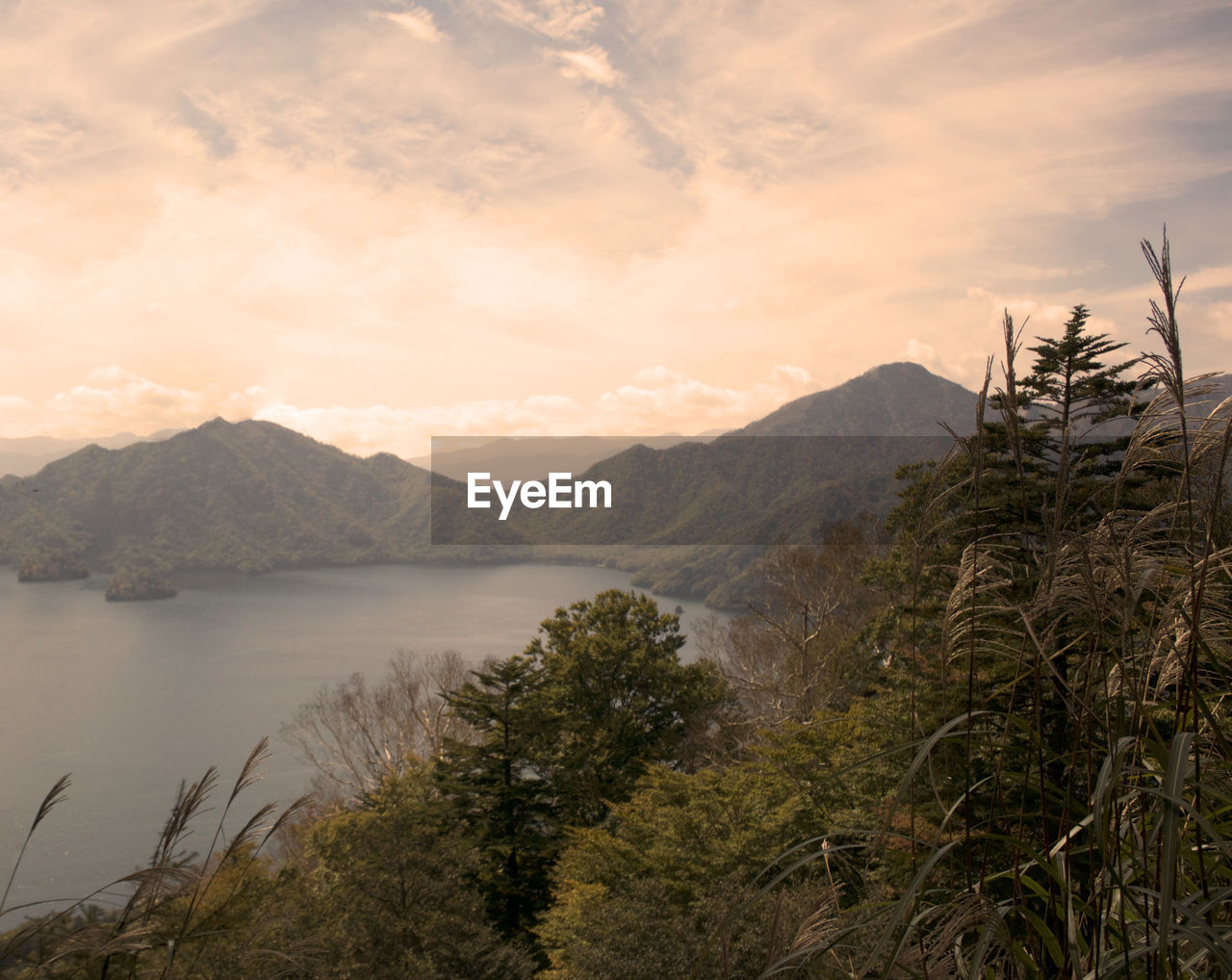 Scenic view of lake by mountains against sky