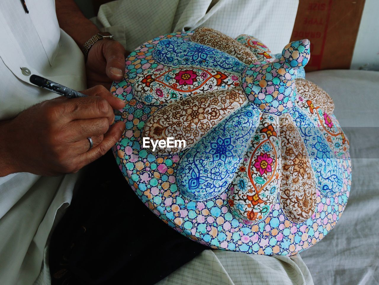 Kashmiri artisan making products of paper mache