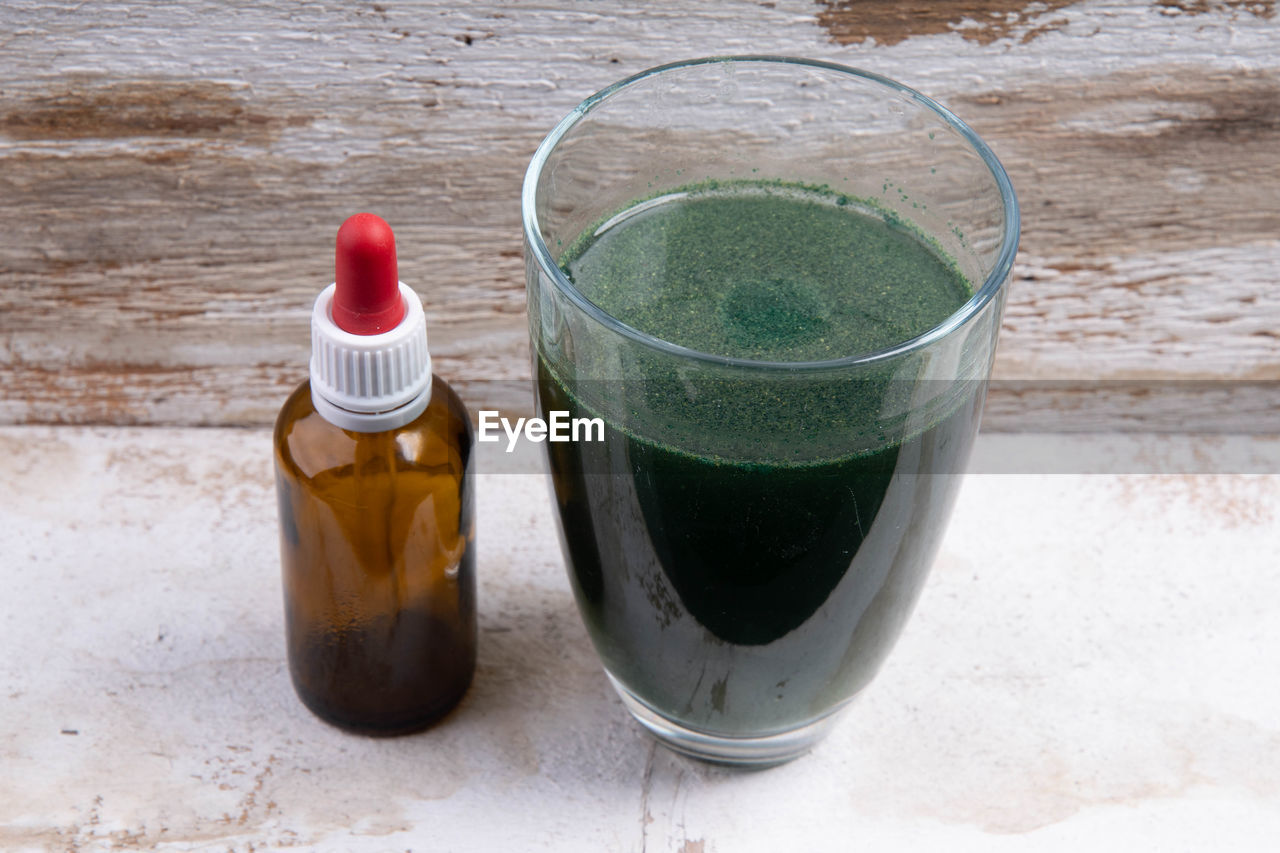 Green smoothie with  brown glass bottle