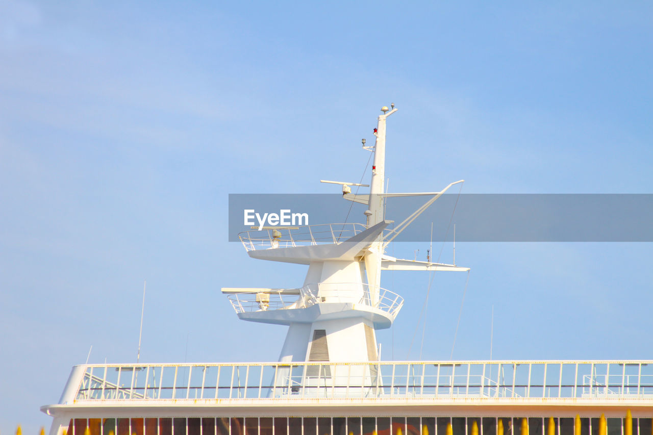 LOW ANGLE VIEW OF WINDMILL AGAINST CLEAR BLUE SKY