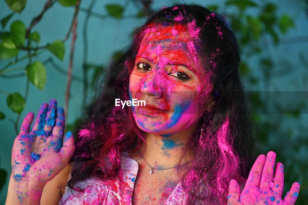 Young girl celebrating festival of colours holi. 