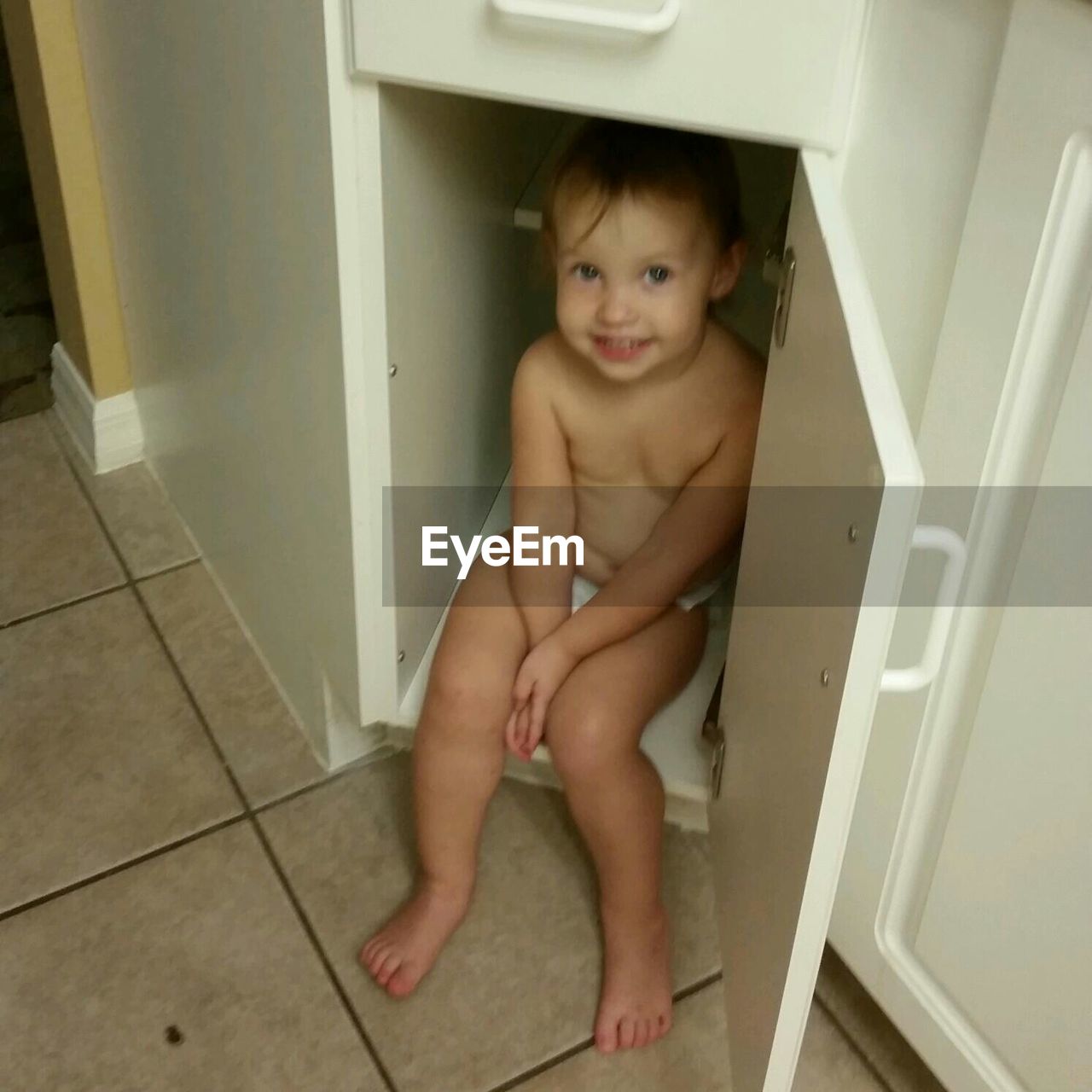 PORTRAIT OF SHIRTLESS BABY BOY IN BATHROOM