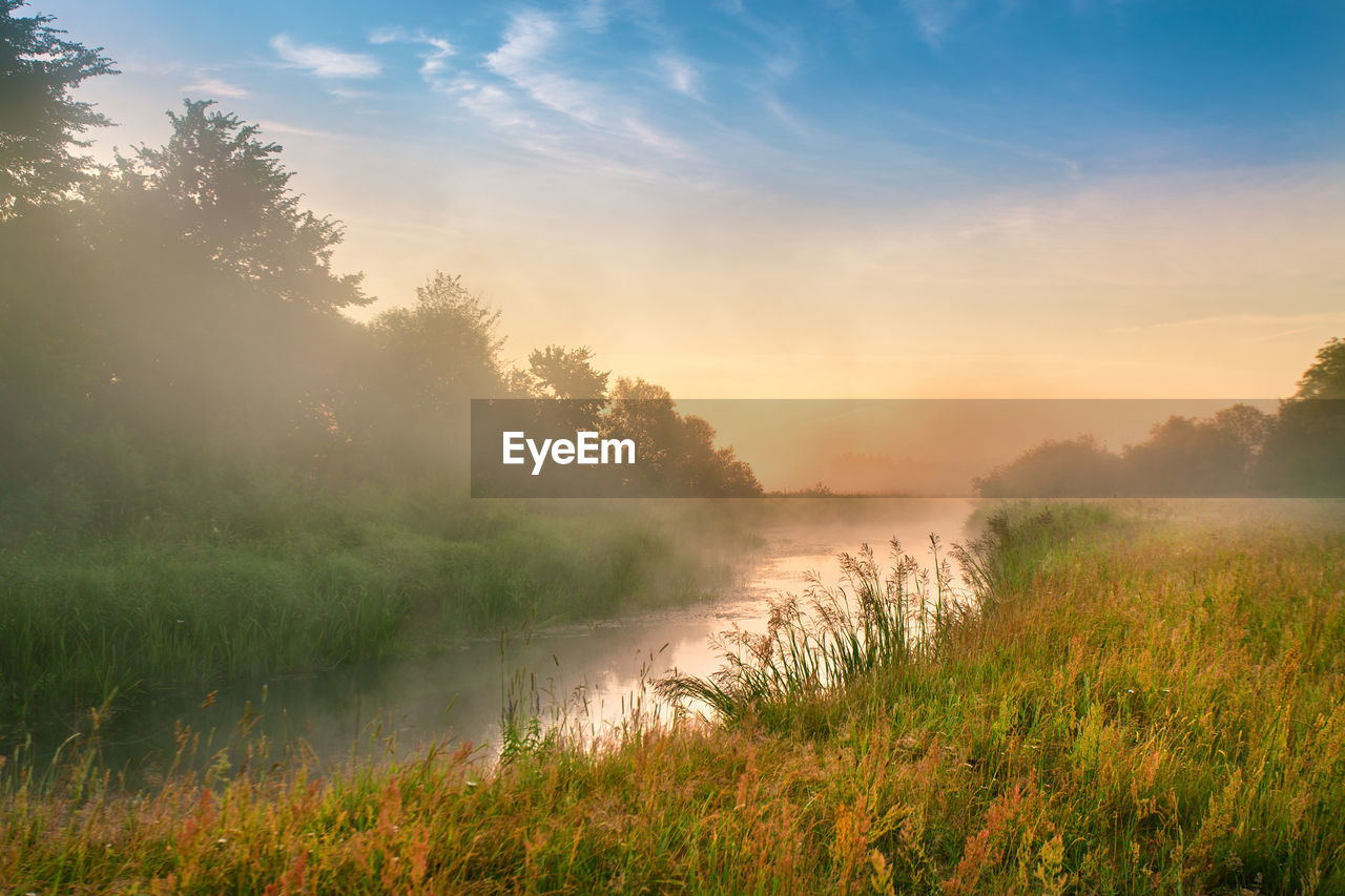 Scenic view of lake against sky during sunset