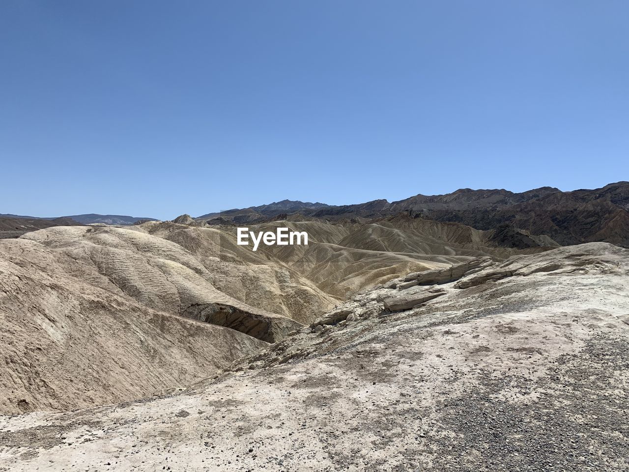 Scenic view of mountains against clear blue sky