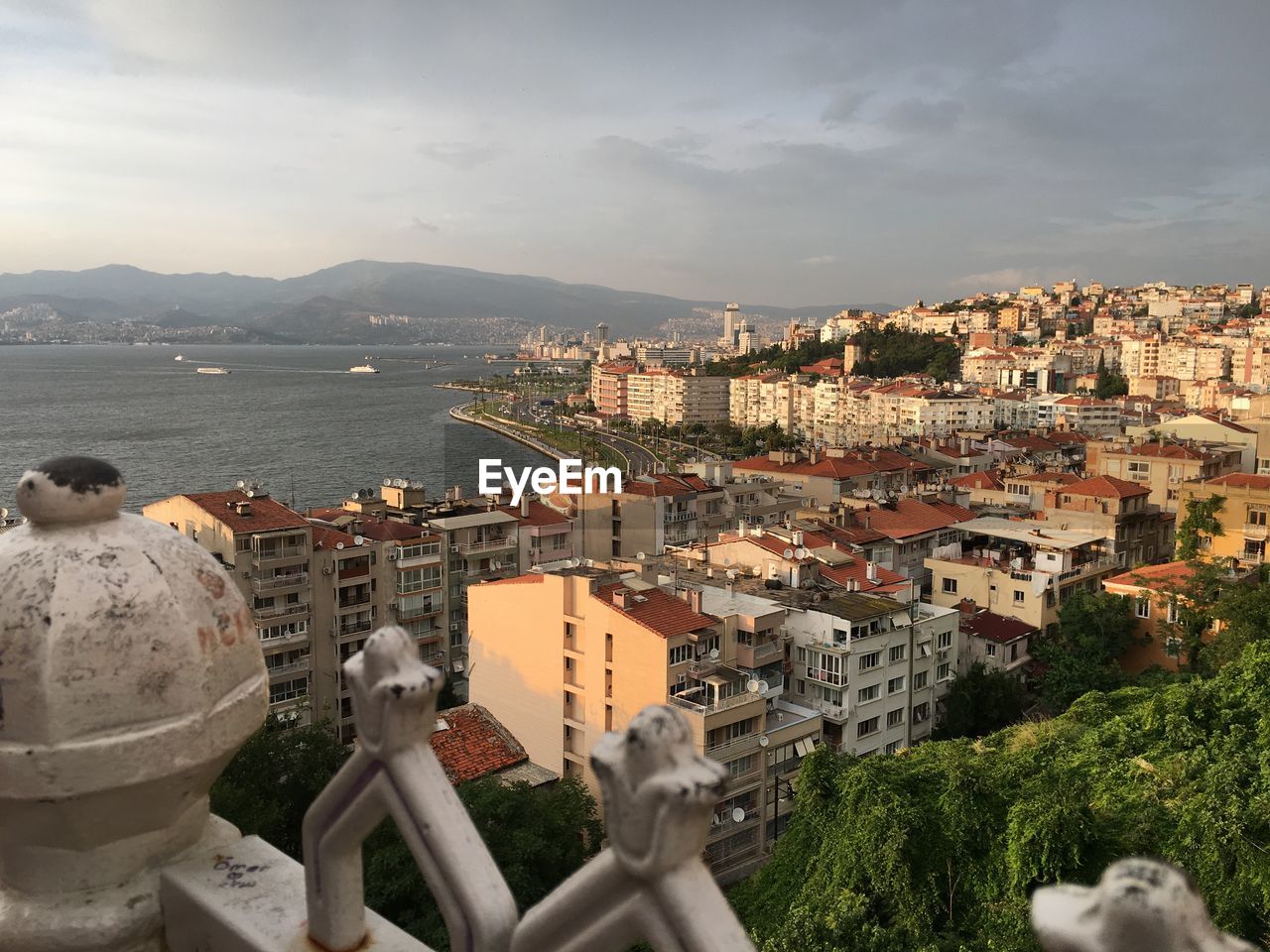 High angle view of buildings against cloudy sky in city