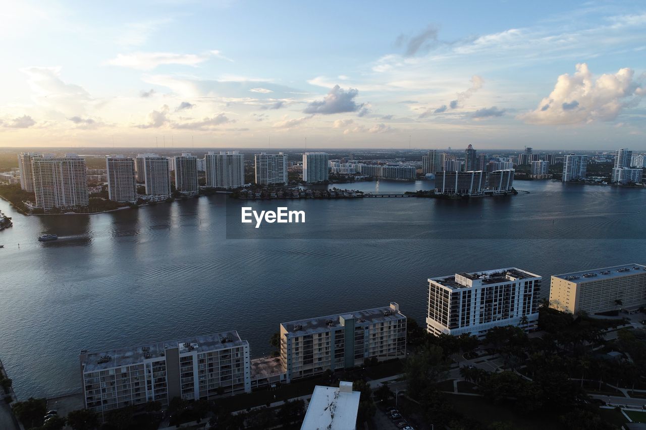 High angle view of buildings by sea against sky