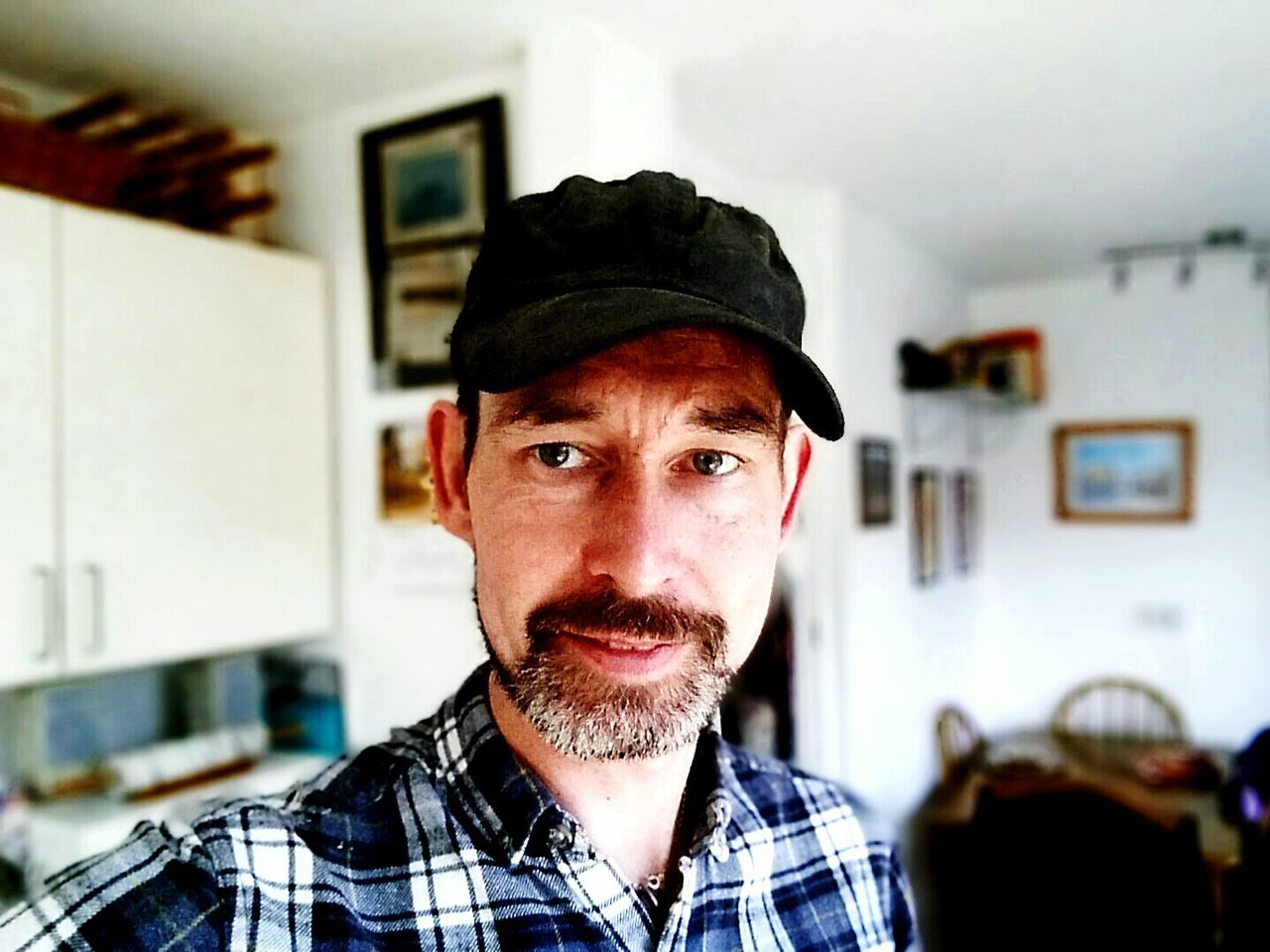 Portrait of man in cap at home