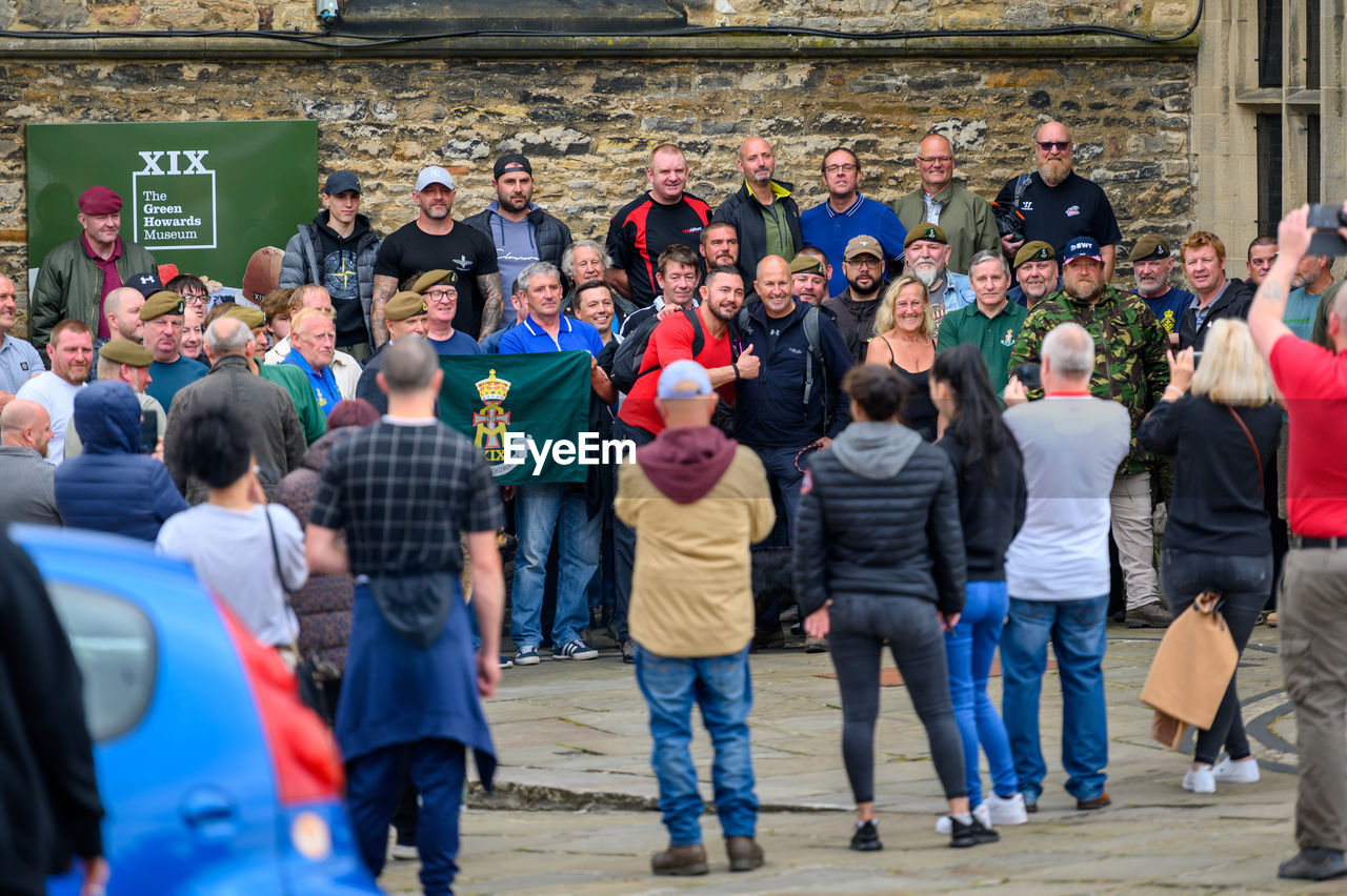 GROUP OF PEOPLE STANDING ON STREET