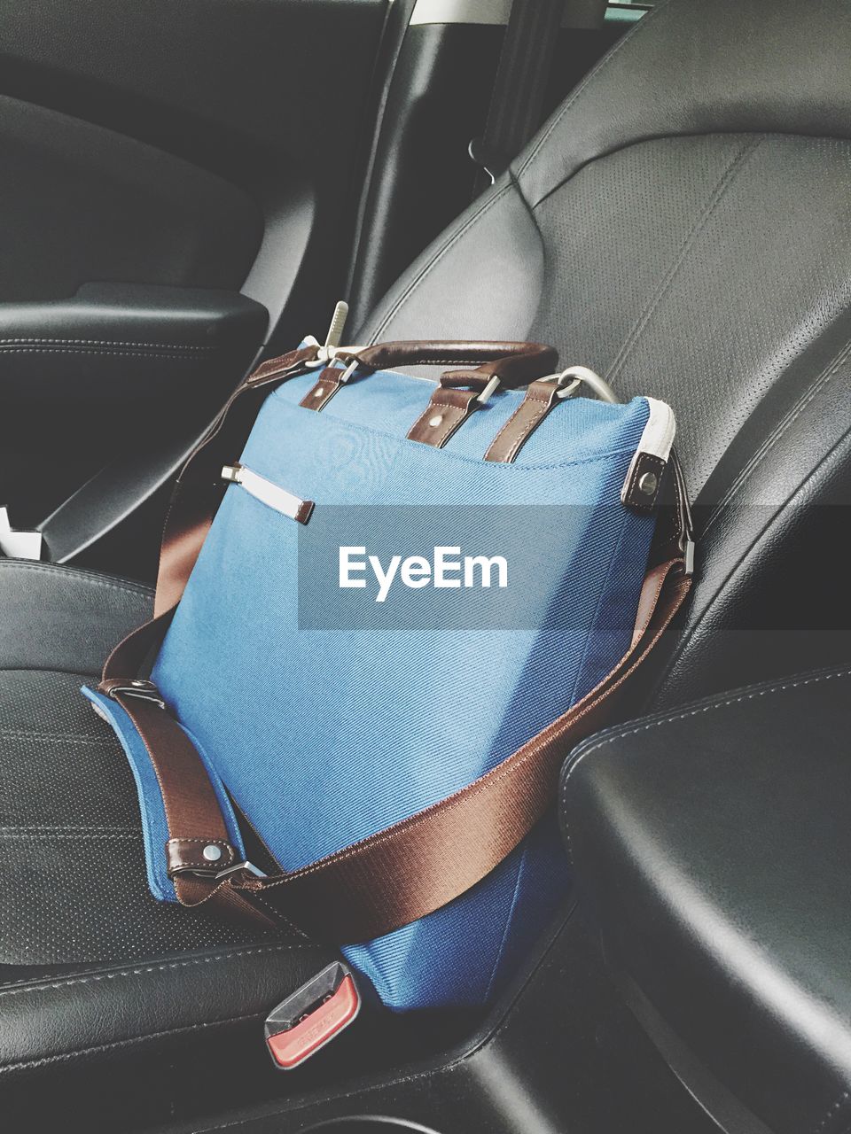 Blue laptop bag on car seat