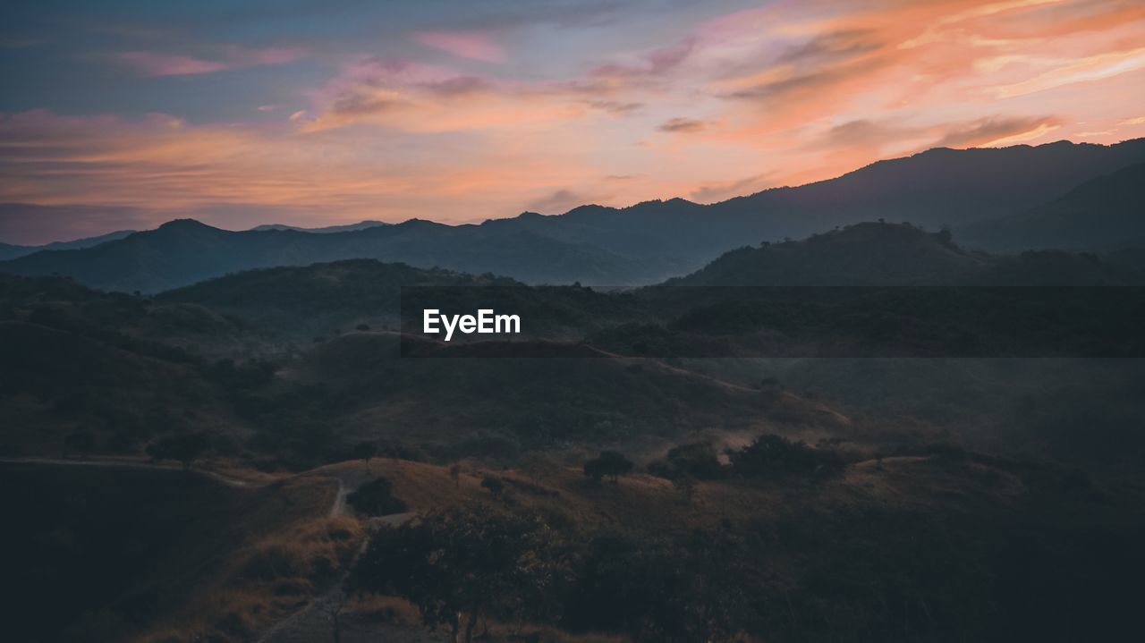 Scenic view of mountains against sky during sunrise