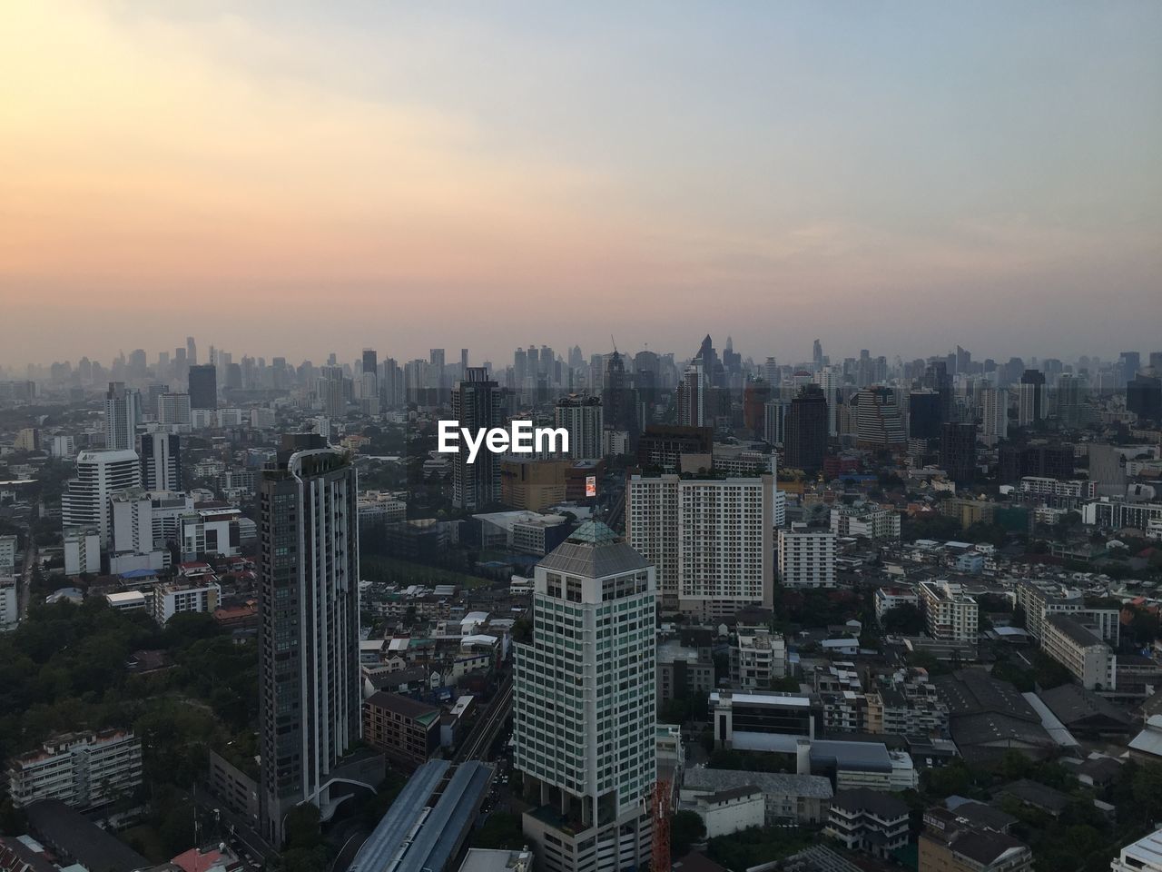 HIGH ANGLE VIEW OF BUILDINGS AGAINST SKY DURING SUNSET