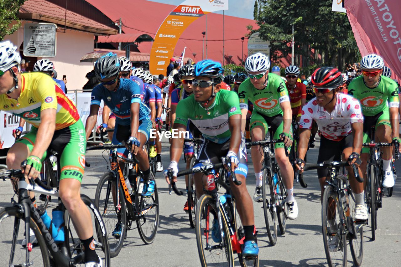 GROUP OF PEOPLE RIDING BICYCLES ON ROAD