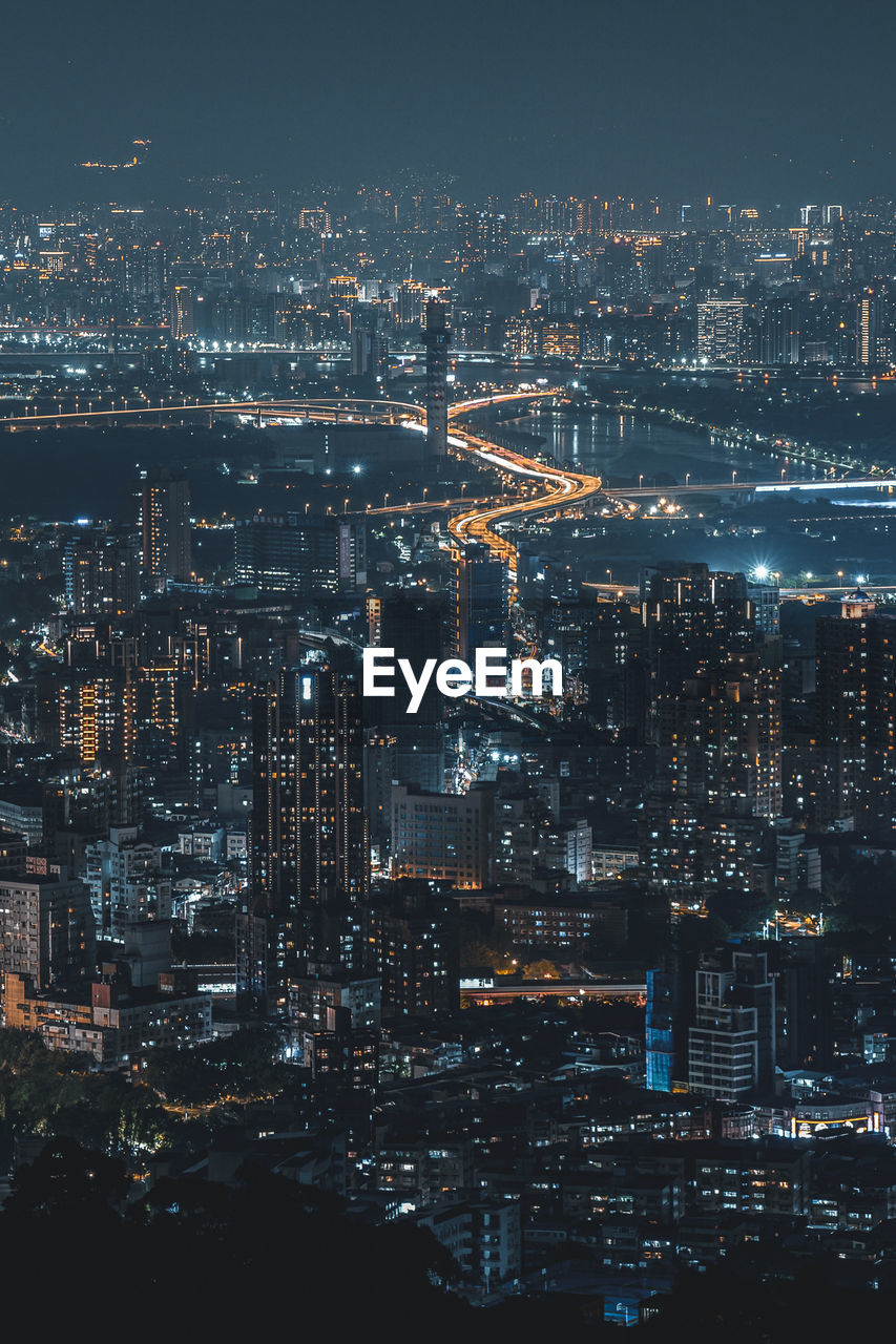 High angle view of illuminated buildings in city at night