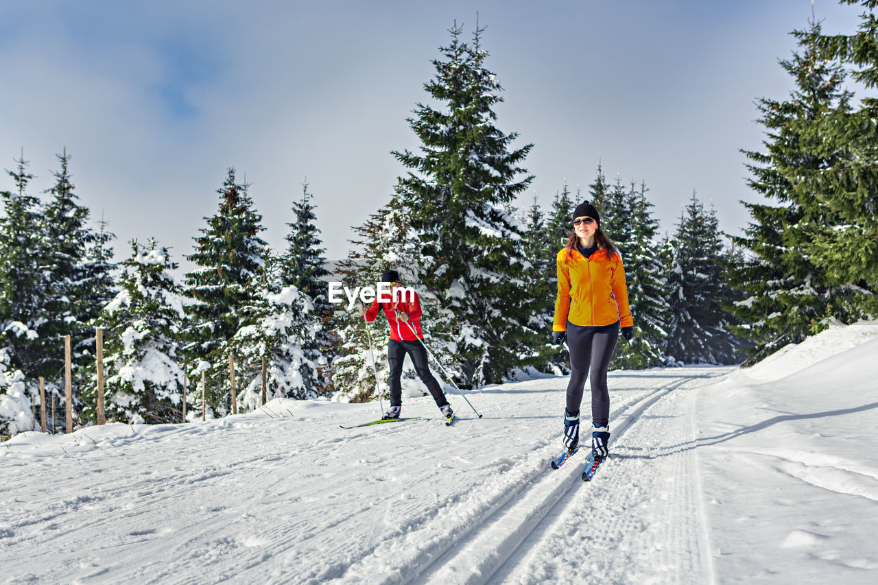 Woman walking on snow covered land