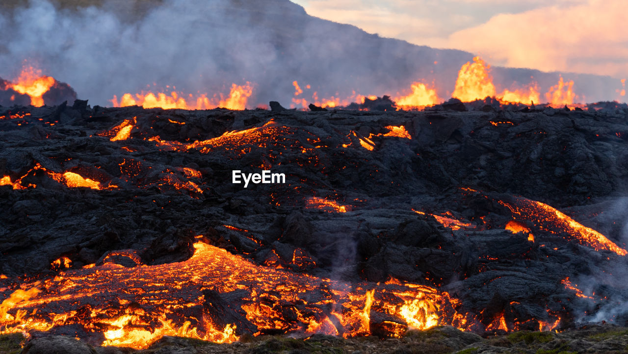 Molten lava flowing from an volcanic eruption in mt fagradalsfjall volcano, iceland, august 2022