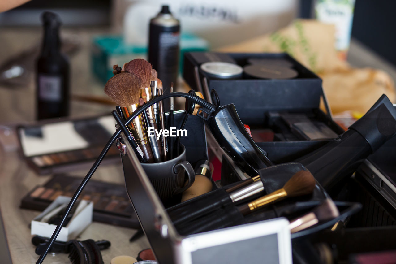 Dedicated focus make-up converter on makeup artist's table with lots of makeup artist tools.