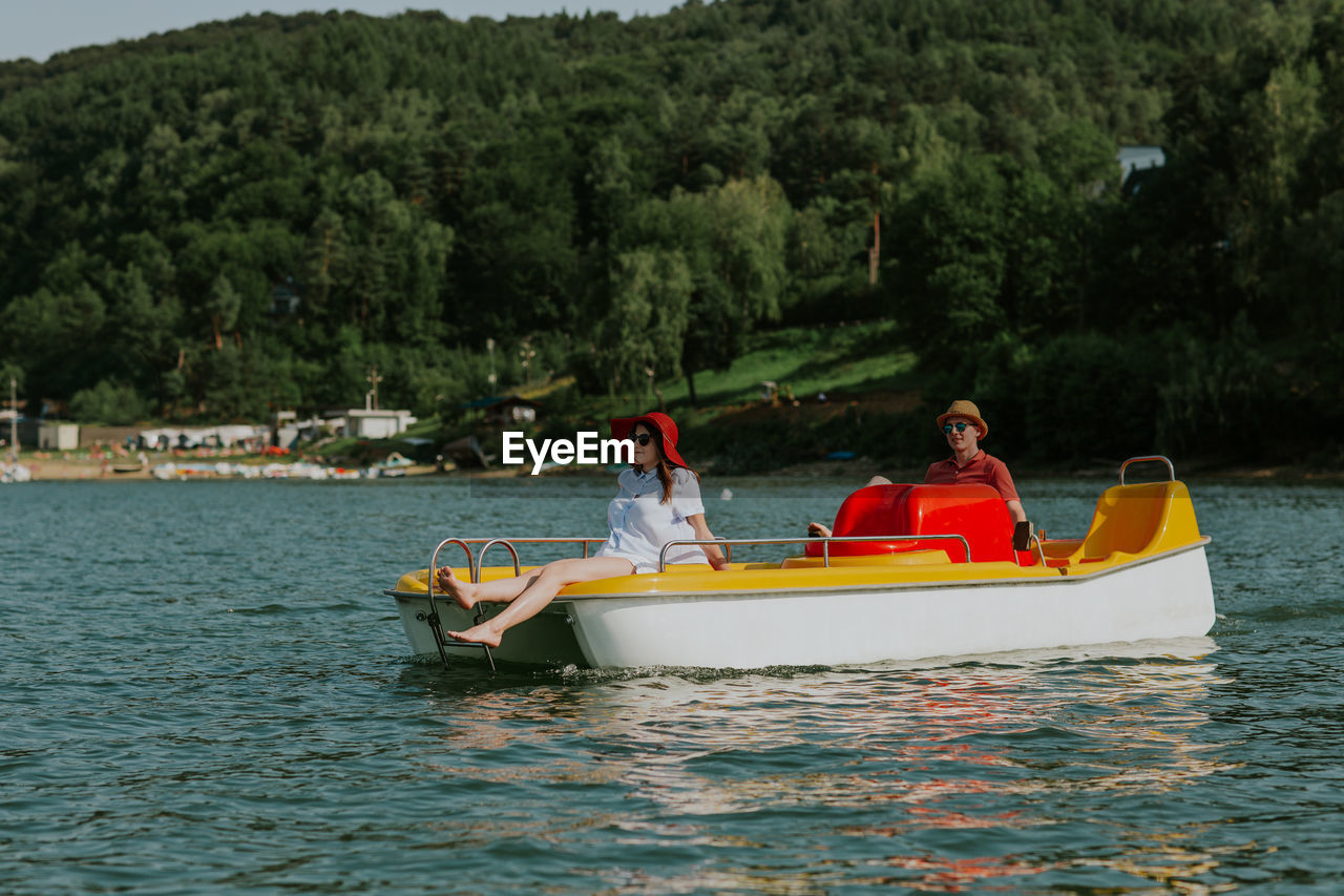 PEOPLE IN BOAT ON LAKE