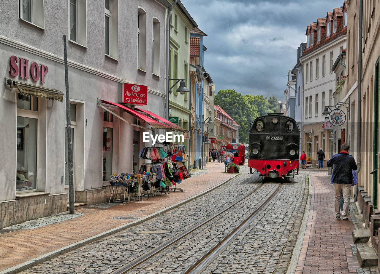 TRAIN ON RAILROAD TRACKS IN CITY