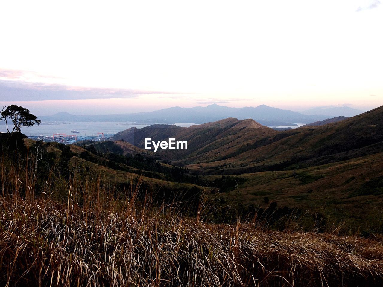 SCENIC VIEW OF LANDSCAPE AGAINST SKY DURING SUNSET