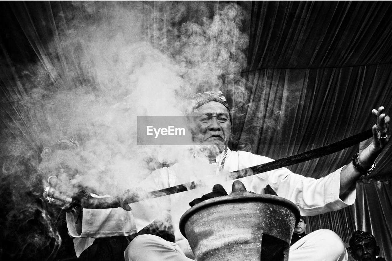 Senior man doing rituals in traditional festival