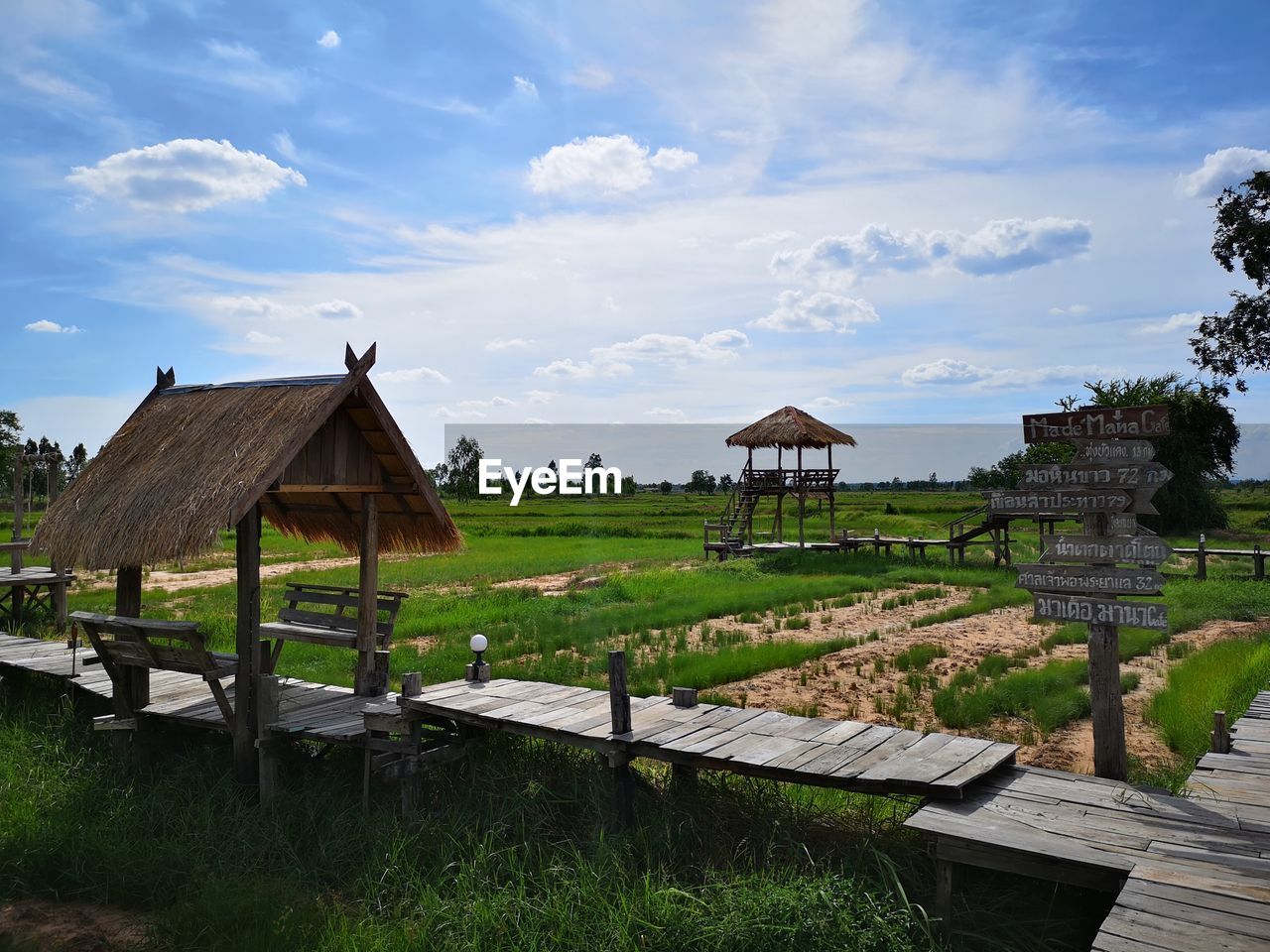 HOUSES ON FIELD AGAINST SKY