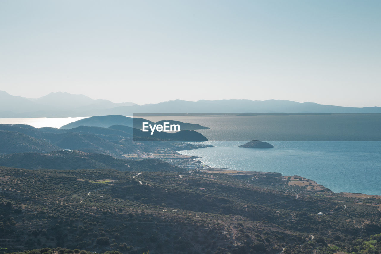 SCENIC VIEW OF SEA AND MOUNTAIN AGAINST CLEAR SKY