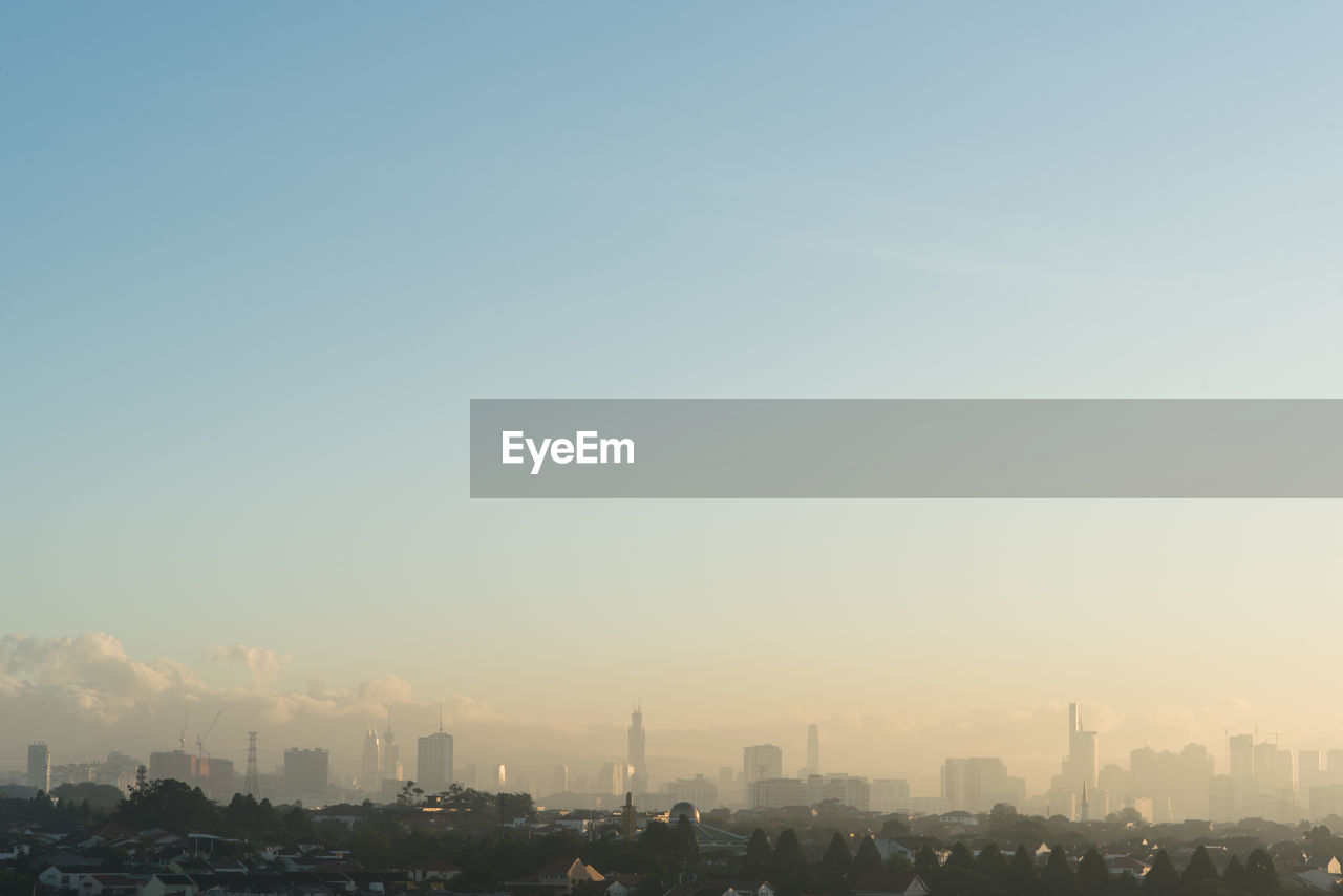 Far view of kuala lumpur city skyline in a hazy and misty morning