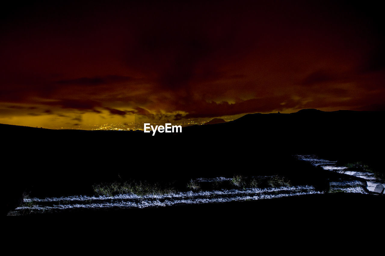 SCENIC VIEW OF SILHOUETTE MOUNTAINS AGAINST SKY DURING SUNSET
