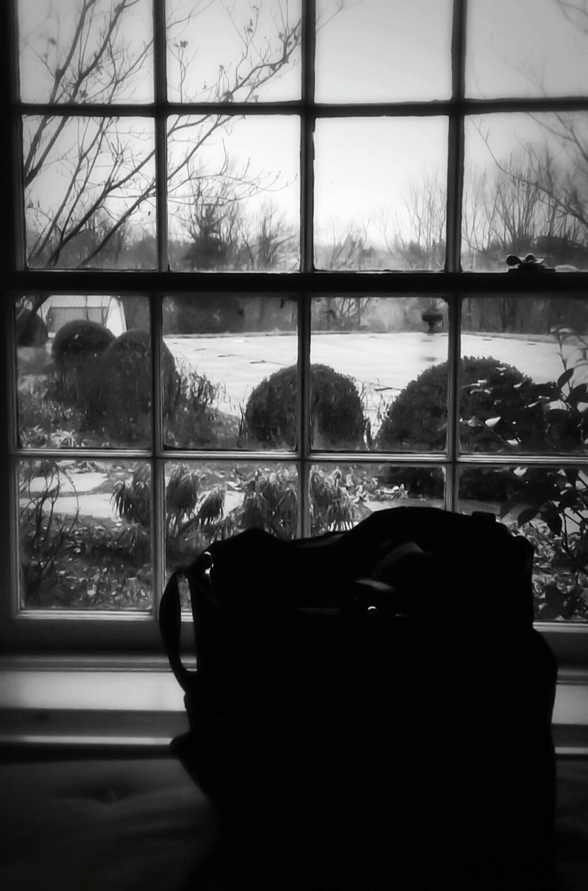 Bag on bed by window at home